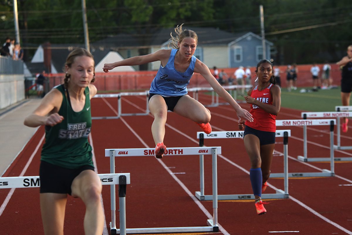 Clearing the second hurdle, senior Josie Benson competes in the 300 meter hurdles.