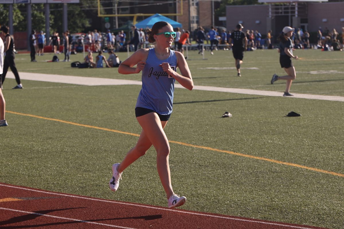 Opening her stride, freshman Lexi Lamberson secures her place in the 1600 meter race.