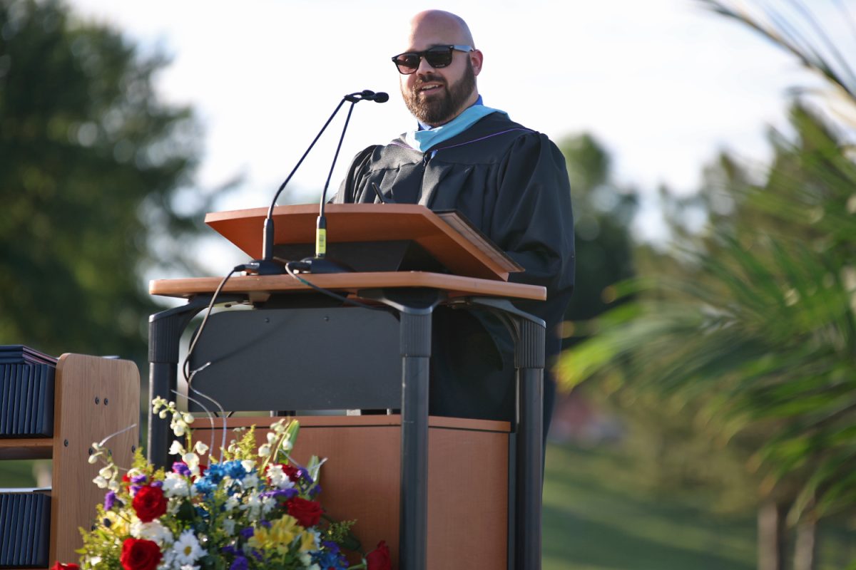 At the podium CTEC teacher Brian Hagstrom gives a speech to the graduates.