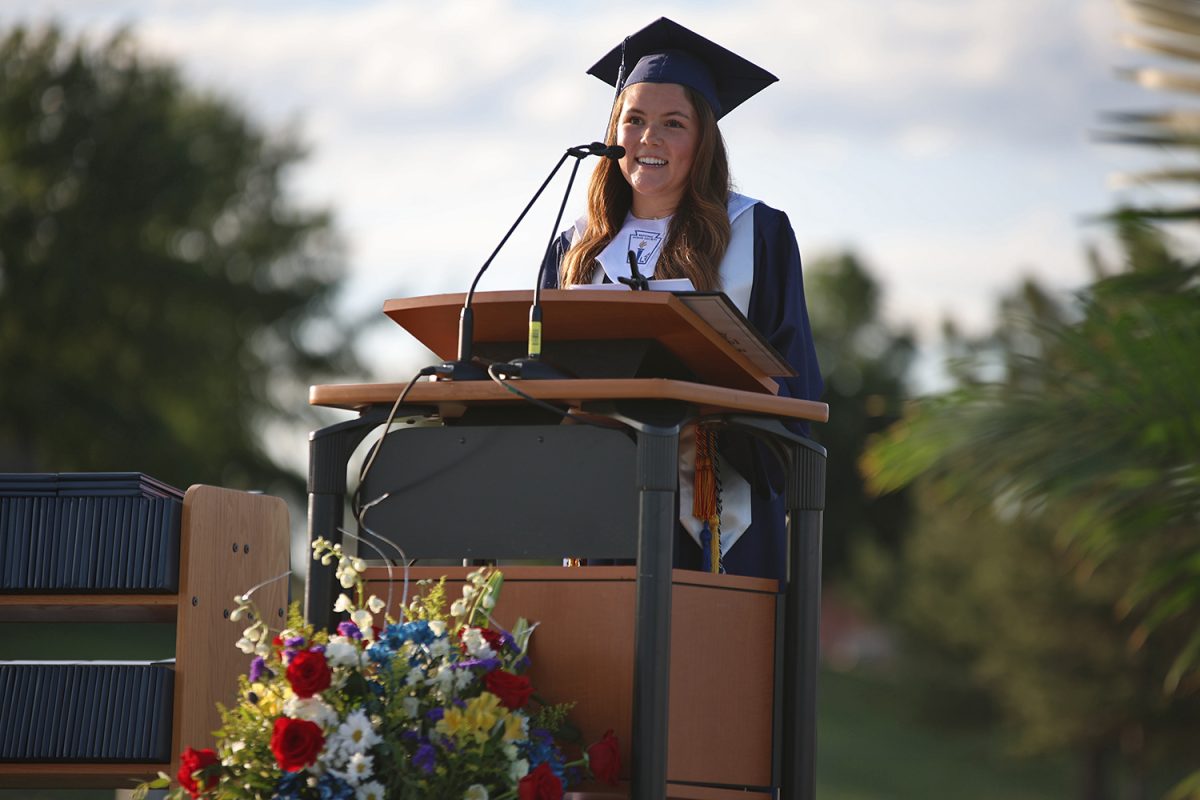 Student Council class president senior Brynn Shideler talks to graduates about the four leaves of a lucky clover.