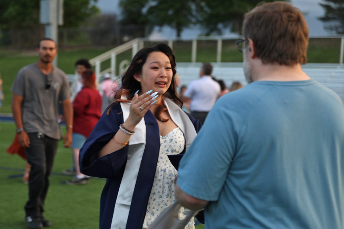 Tears in her eyes, senior Davin Bickerstaff runs to hug a family member.