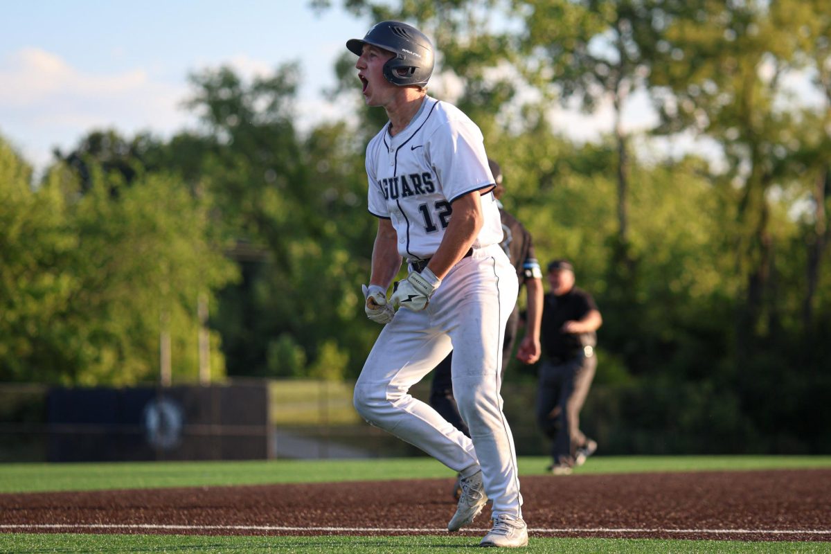 Yelling towards the first base coach, senior Hudson Powers celebrates after getting on base.