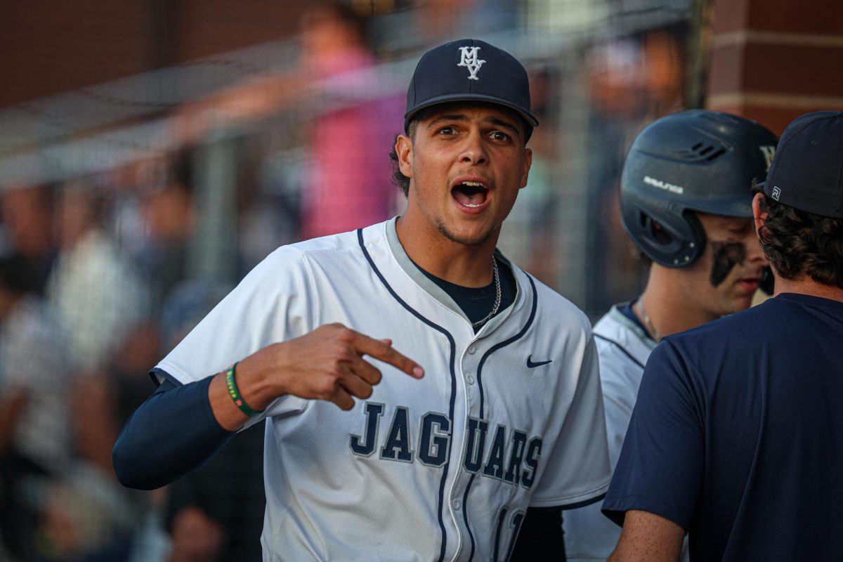 Motivating the team, senior Jake Hobbs helps the team make a comeback.