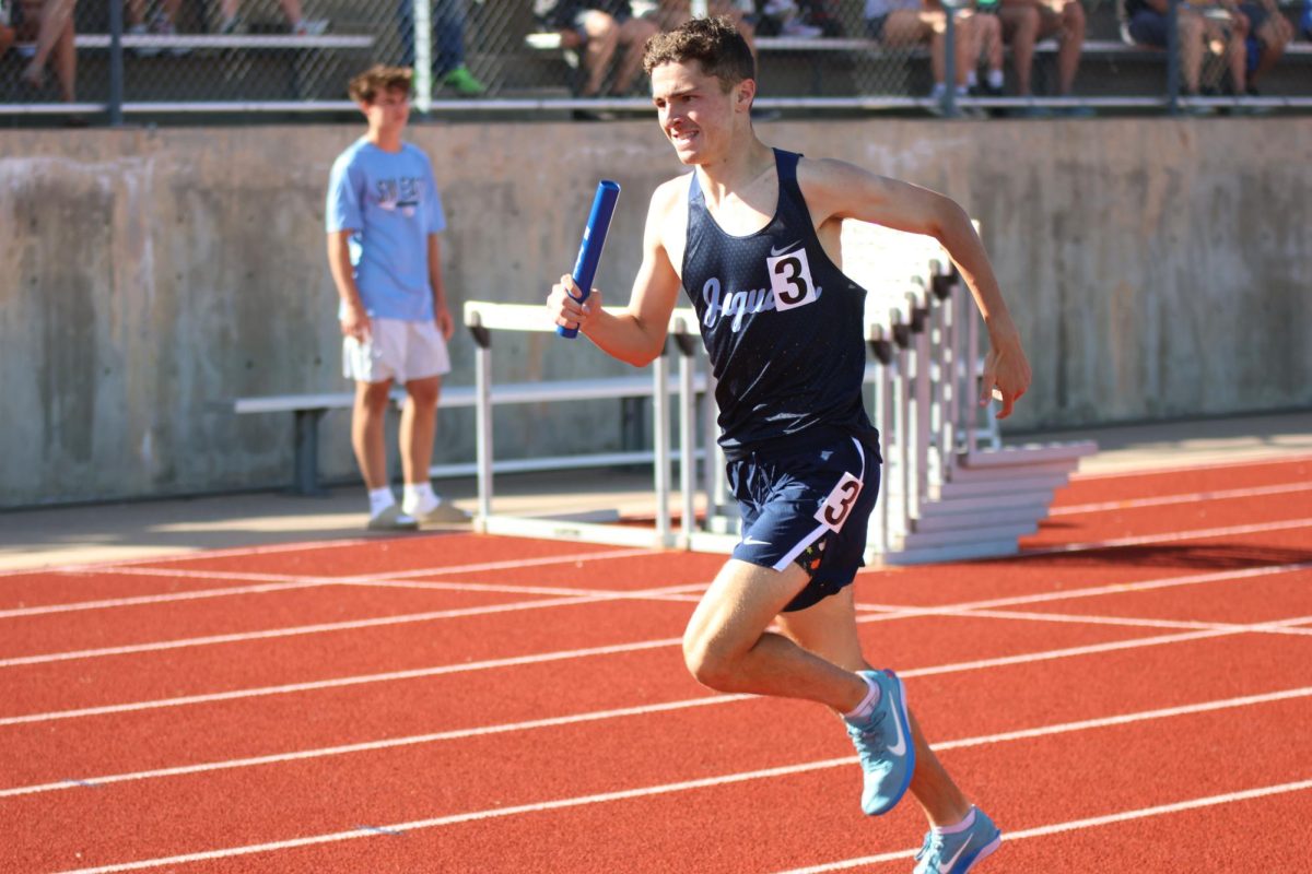 Junior Gus Malone sprints for the finish line as the last leg in the boys 4x800m relay on May 15. 