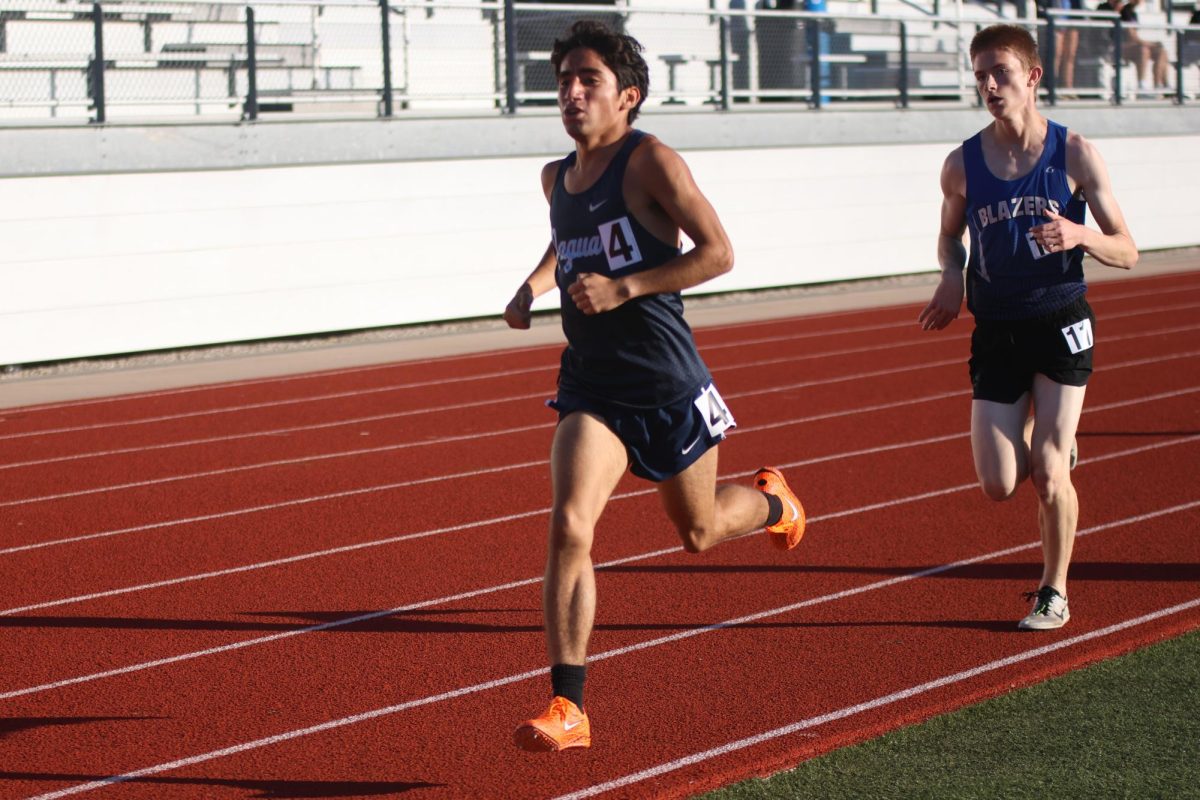 Senior Yazid Vasquez doesn't let an opponent pass him in the boys 1600m on May 15. 