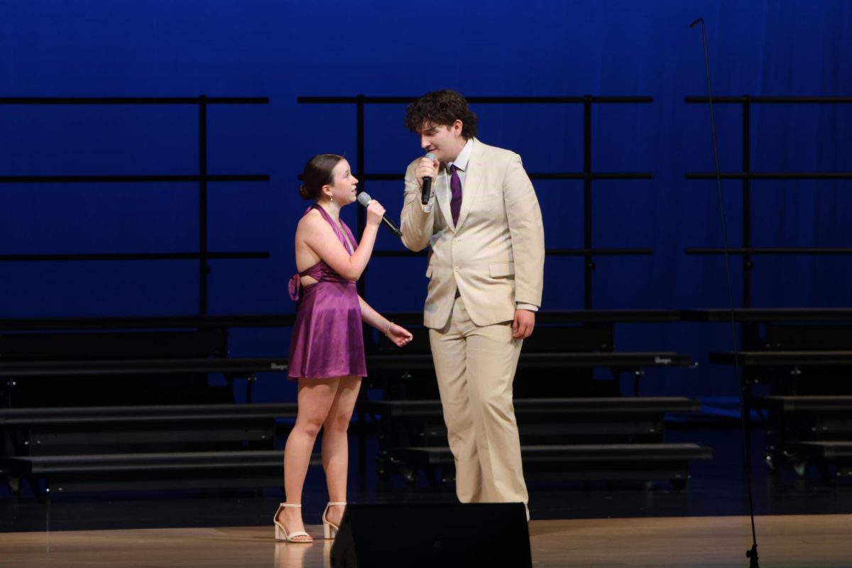 Performing their duet, seniors Reese Miller and Blake Gray sing together.