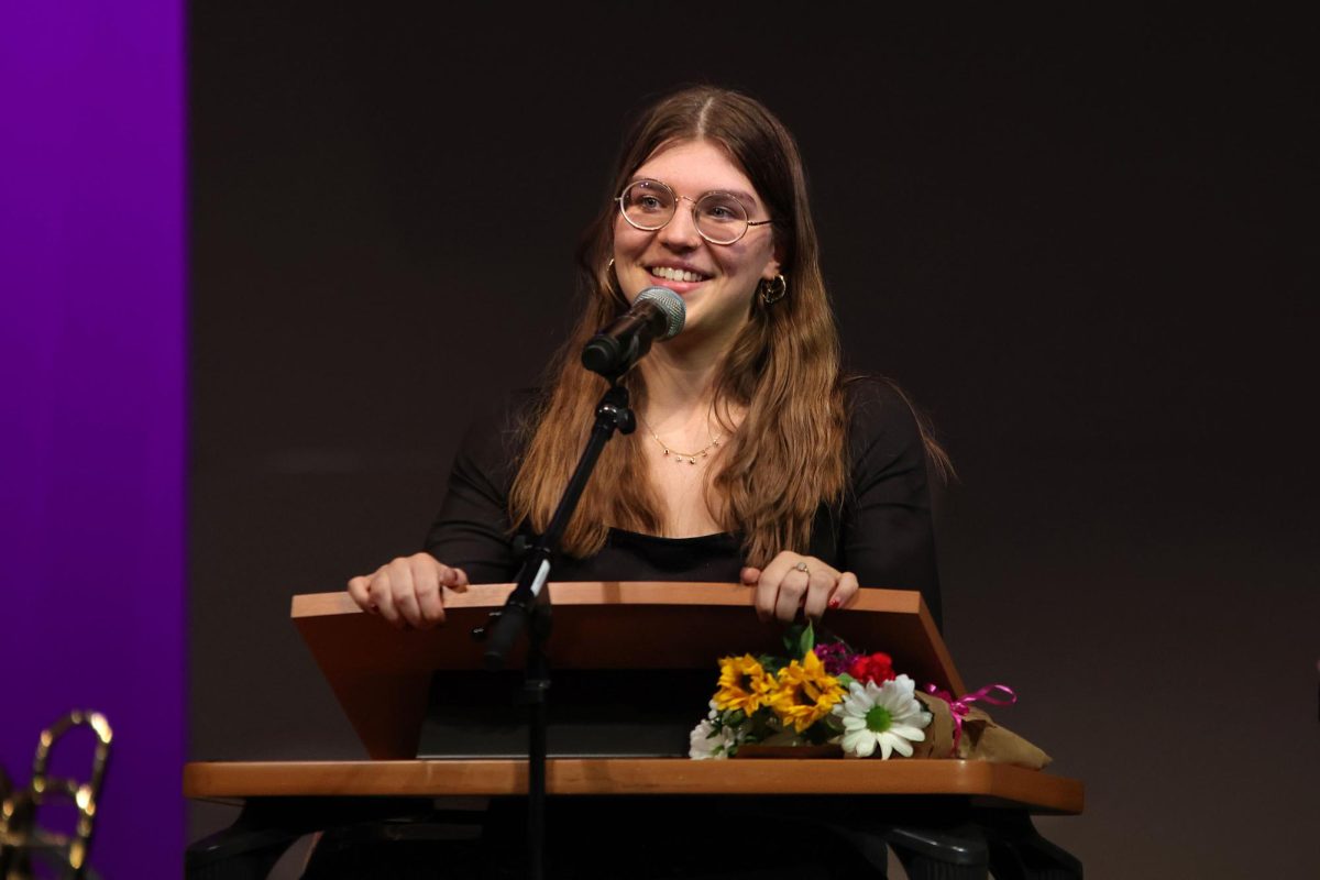 Smiling, senior Joah Clark delivers a speech at the end of the concert. 