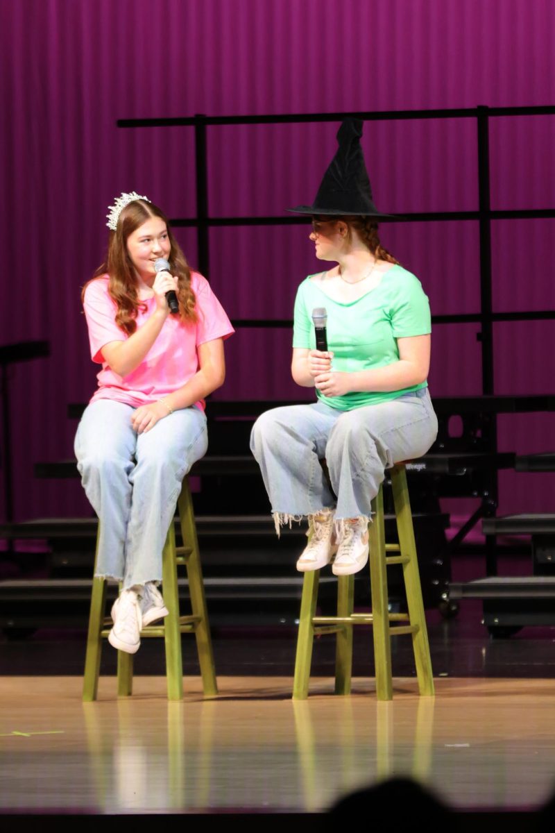 Freshman Zoe Wendel looks at sophomore Charlie Barrett while singing.