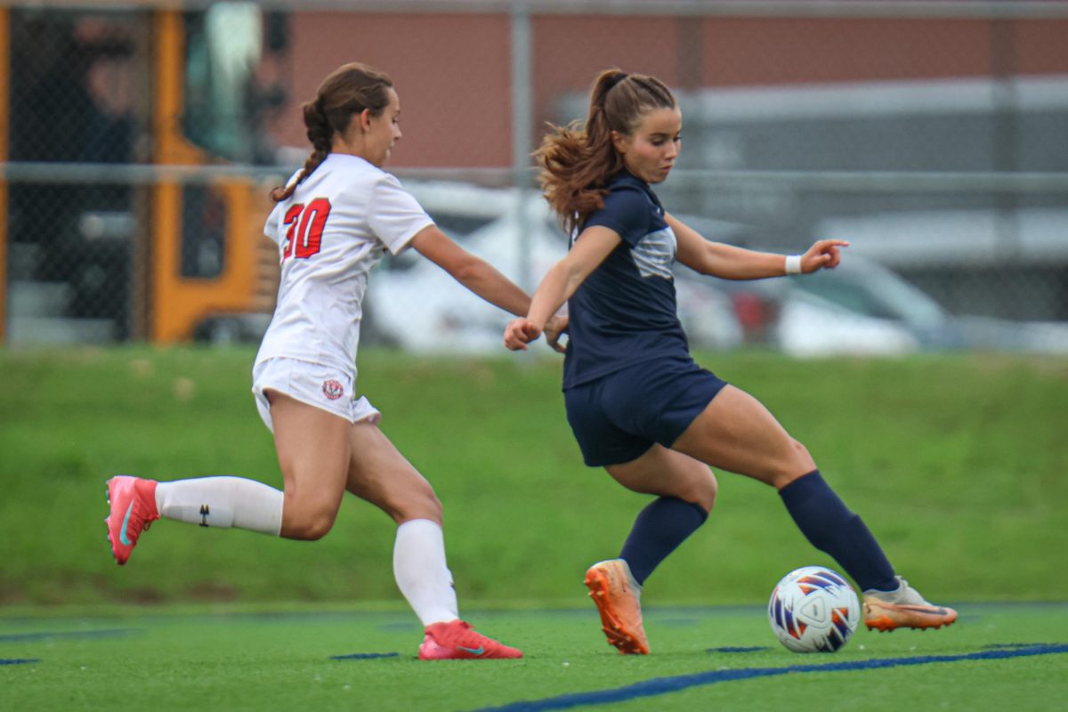 Turning her back, senior Lauren Welch evades her defender. 