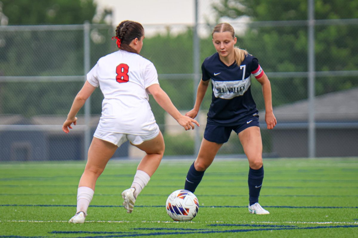 Watching the ball, junior Jenna Lloyd defends her opponent. 