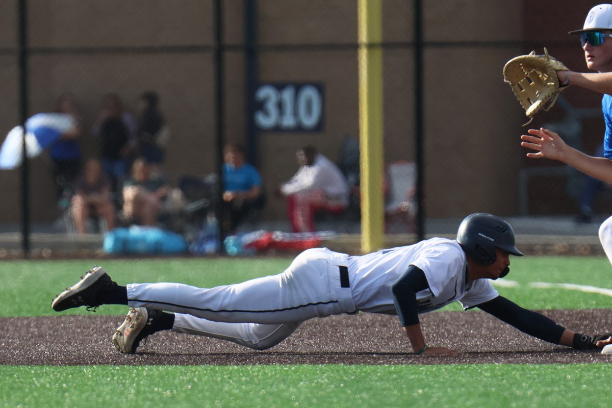 Diving, senior Jake Hobbs gets back to the bag in the first game of regionals. 