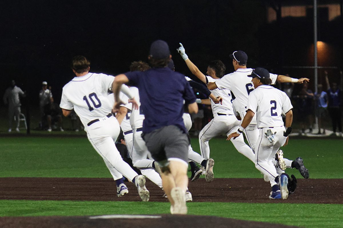 Winning the second game of regionals, the team runs around the field in excitement.