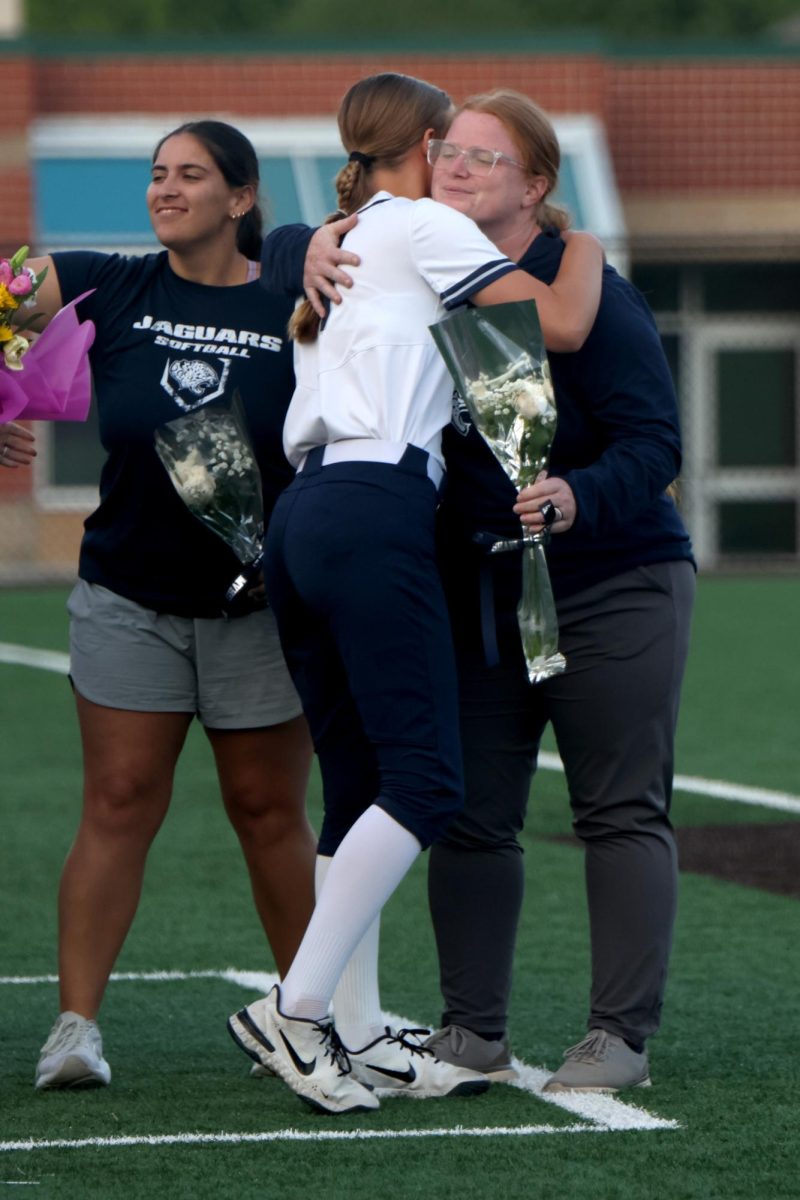  After being recognized on senior night, senior Addie Riffel hugs JV coach Ashley Copeland.