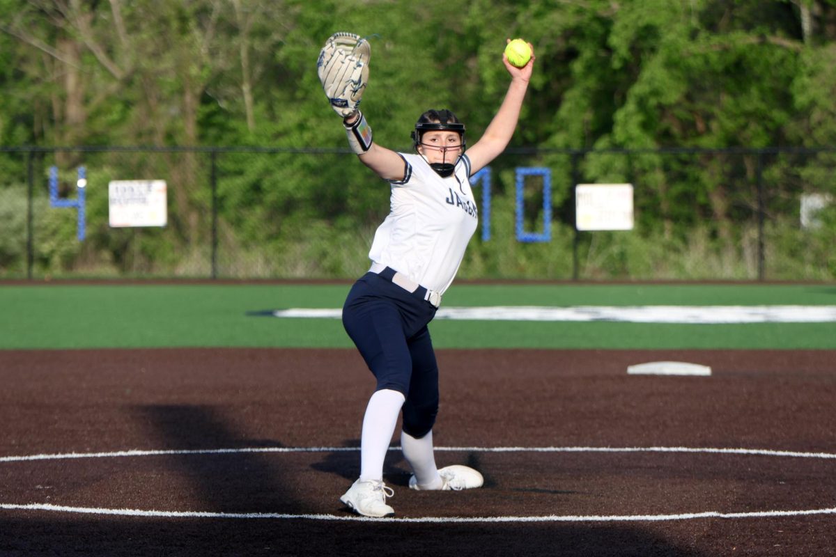 Arm in the air, sophomore Emma Hadley winds up her pitch.
