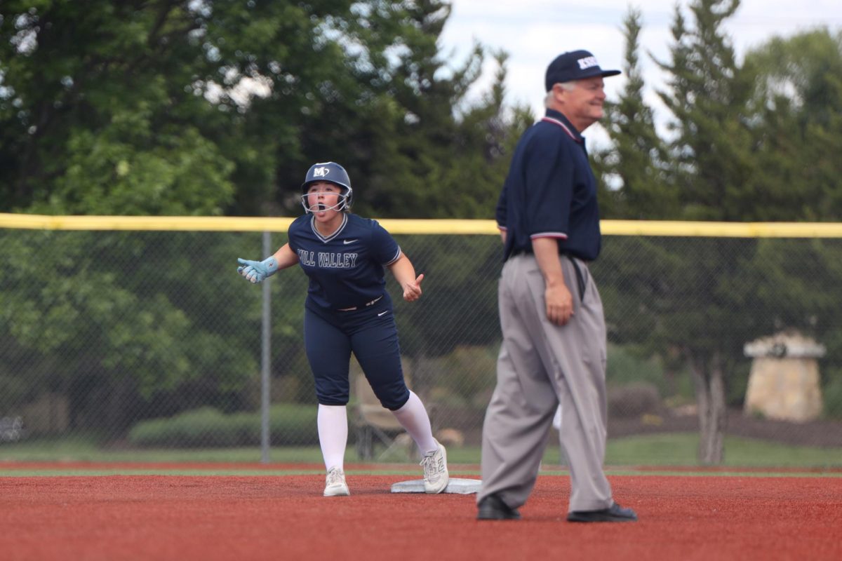 Standing on second base, freshman McKenna O’Leary cheers in the first round of the regional tournament Thursday, May 22.
