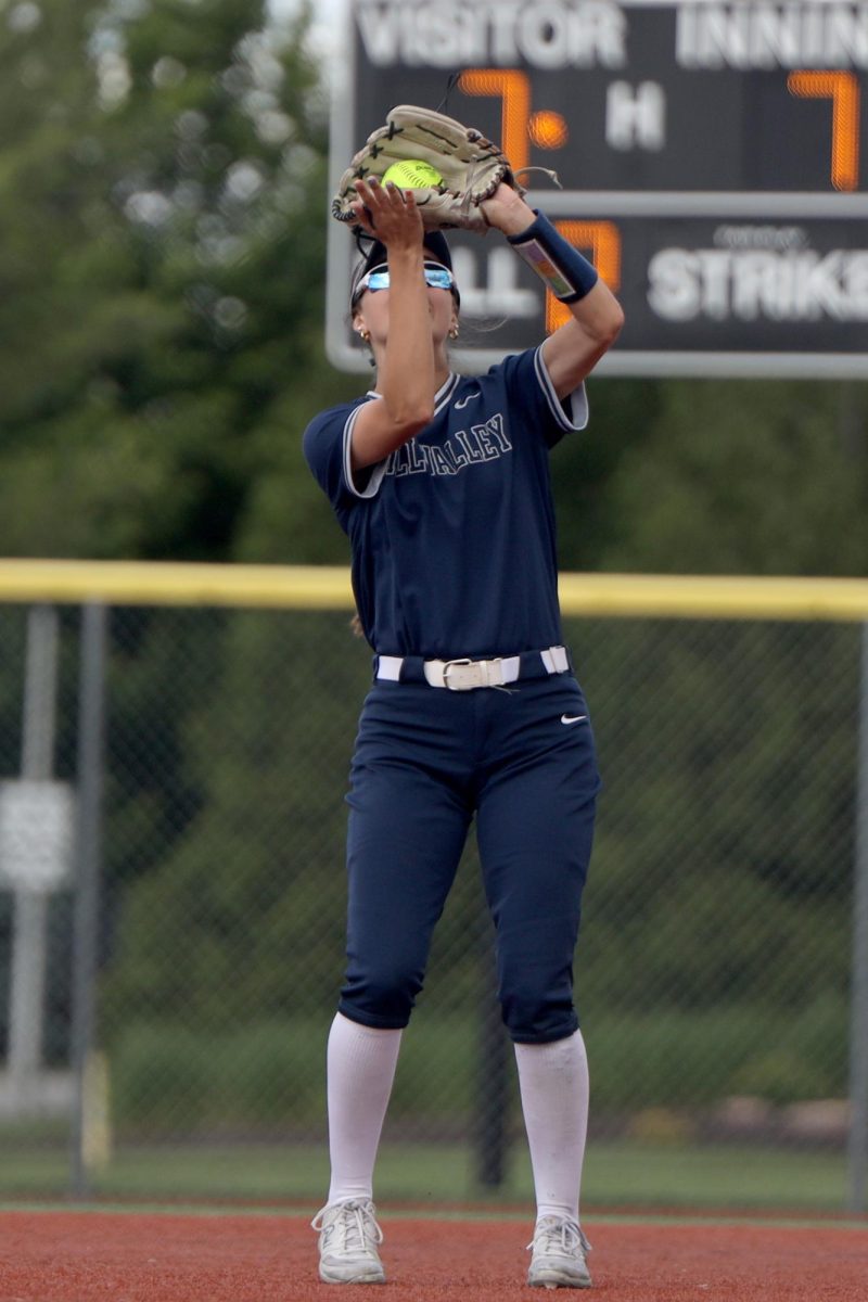 Hands in air, senior Madi Lehr catches a fly ball in the first round of the regional tournament Thursday, May 22.
