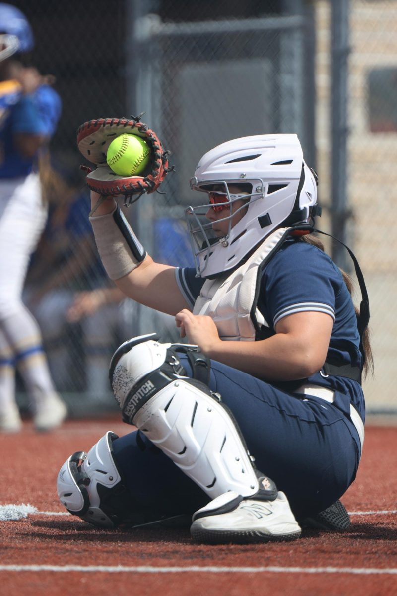 Ball in glove, freshman M McKenna O’Leary catches a strike in the first round of the regional tournament Thursday, May 22.