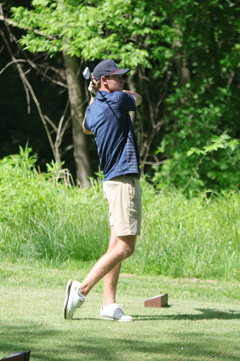 After hitting the ball, sophomore Eli Platz follows through on his swing. 
