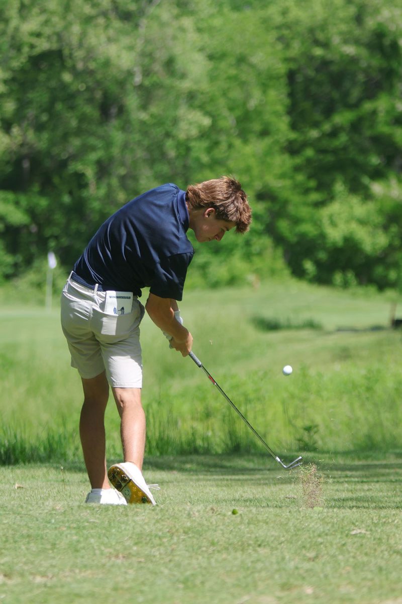 Mid swing, junior Brayden Repp drives the ball. 
