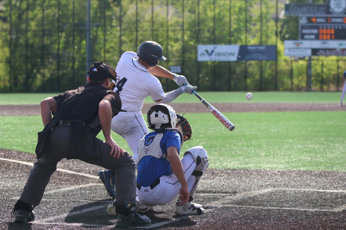 Eyes on the ball, junior Jackson Lucht swings at the ball.