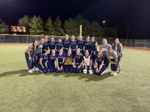 The softball team celebrates their first regional title since 2019 after defeating Olathe Northwest Thursday, May 22.
