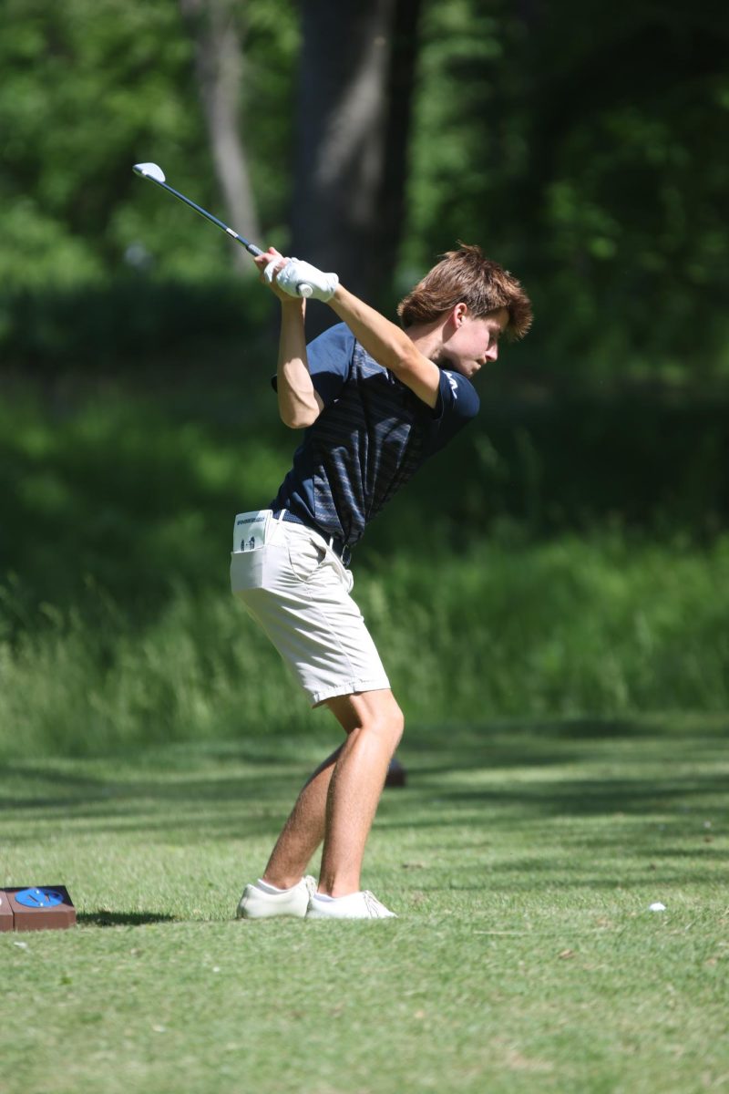 Approaching the ball, junior Bradyen Repp takes a practice swing. 

