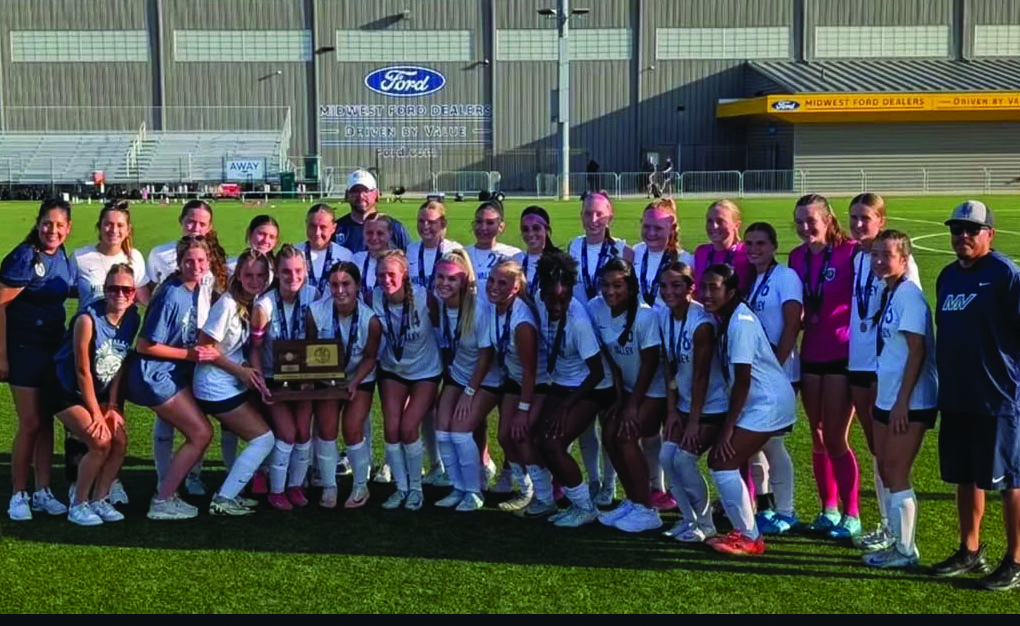 Members of the state runner-up team celebrate with their trophy Saturday, May 31. The Jags lost 4-1 in penalty kicks to Washburn Rural in the 6A state finals.
