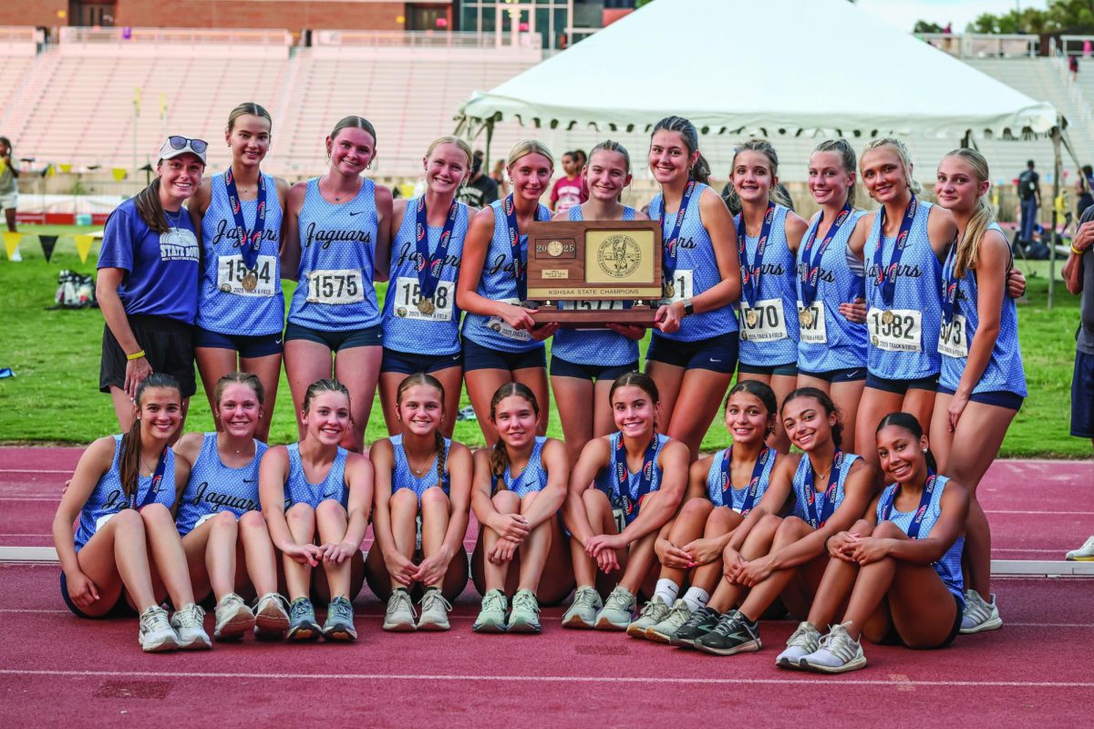 After defeating Manhattan for the 6A state title, the girls team celebrates with their trophy and individual Saturday, May 31 in Wichita.