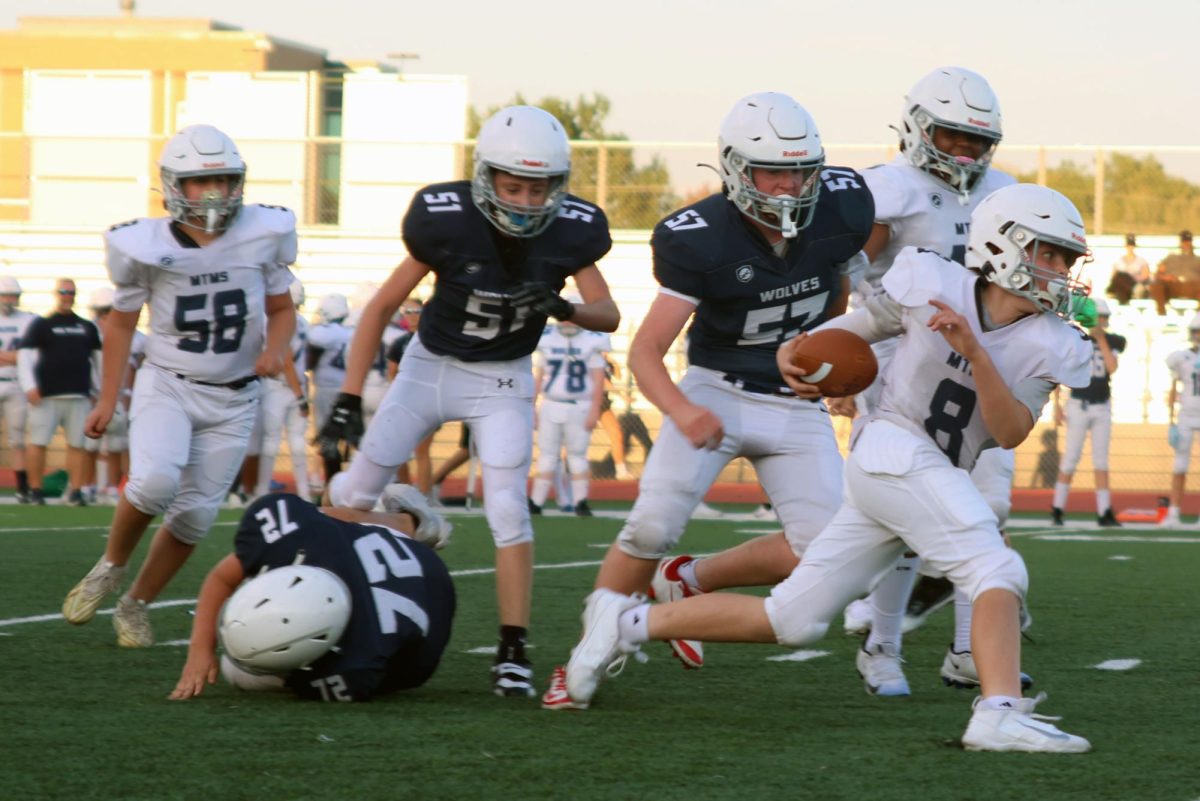 Ball in hand, the Monticello Trails Middle School football team member makes a break away from the defense.