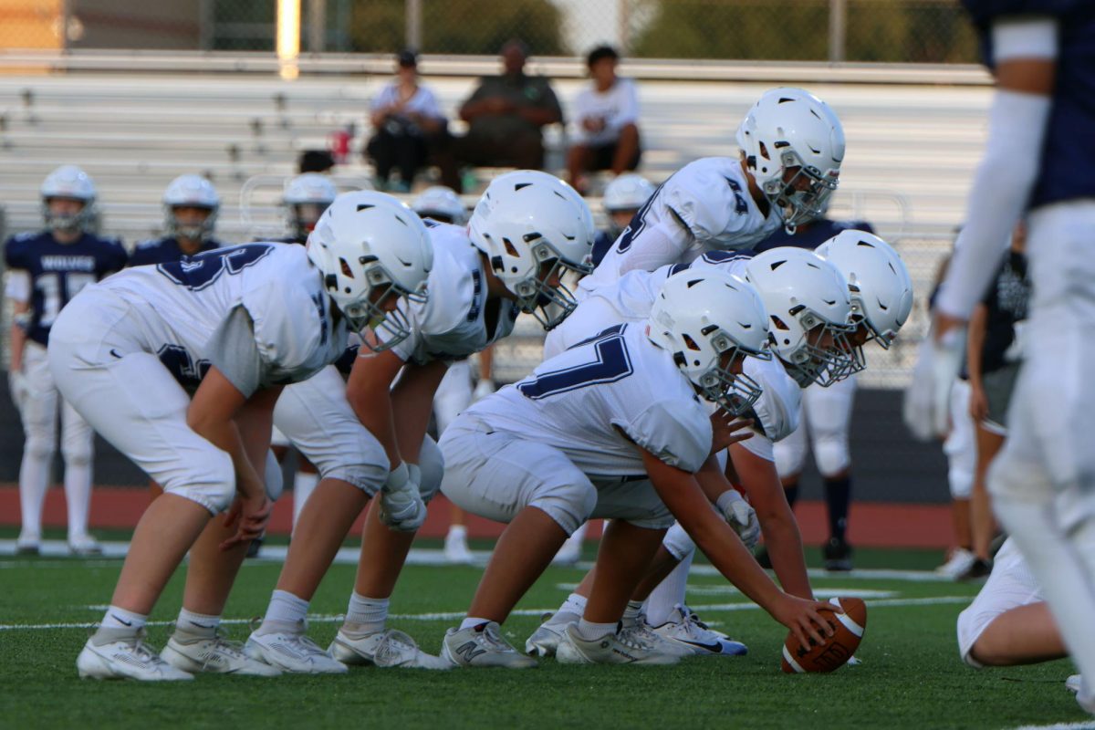 Ball to the ground, middle school Wolves team prepares to begin their scrimmage.