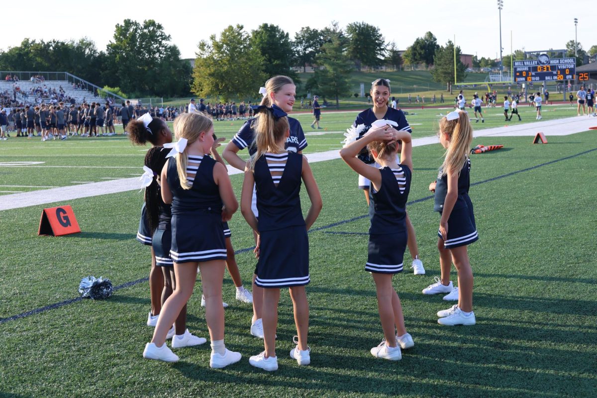 Sophomores Aubrey Birdsong and Julianne Robinson play a cheer game with the Junior Jag cheerleaders in between the middle school and high school scrimmages. 