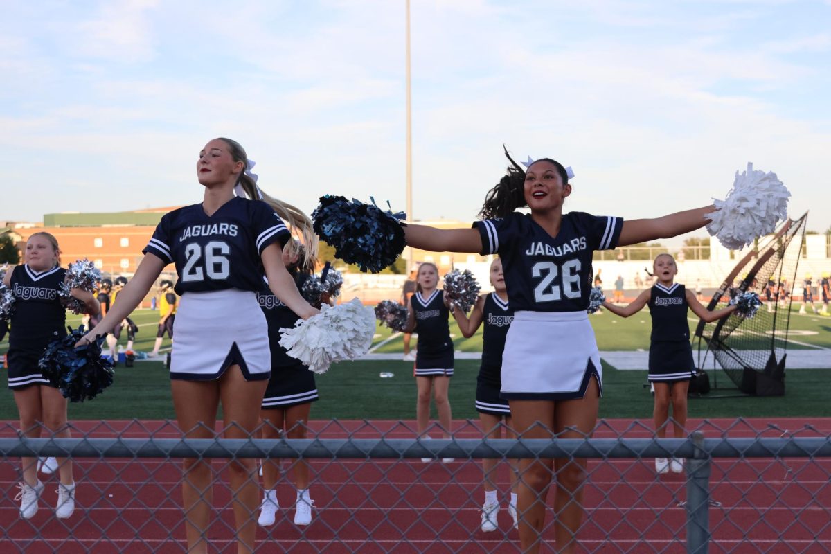 Senior Callaway Clifton and Senior Stella Beins lead the Junior Jag cheerleaders in hyping up the crowd, Thursday Aug. 28.