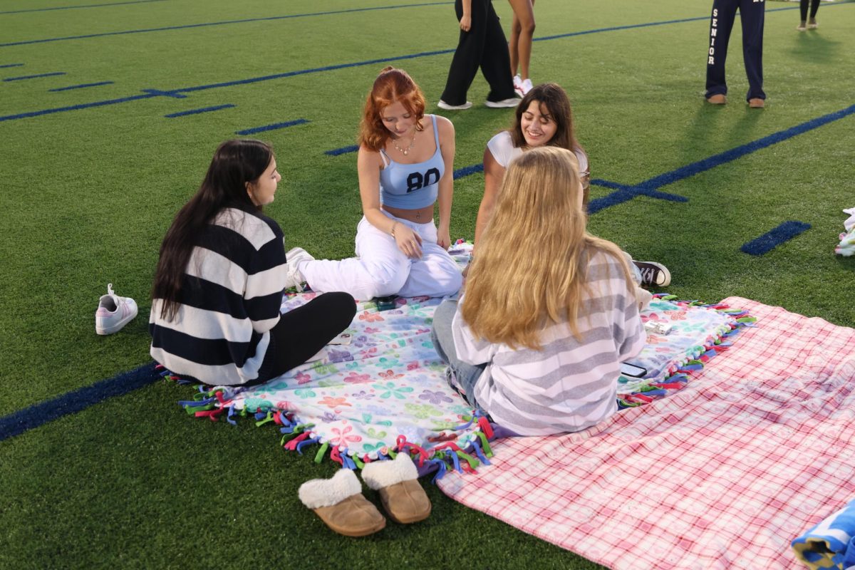 Laughing, seniors Eva Hood, Mylah Vanderhoorn and Mariana Loya talk while the sunrises. 