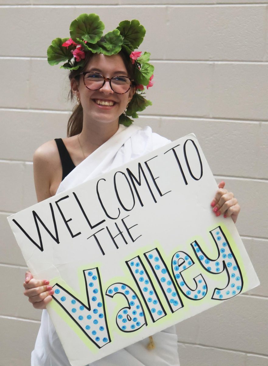 Looking forward and smiling, sophomore Leah Tucker greets the incoming freshmen.