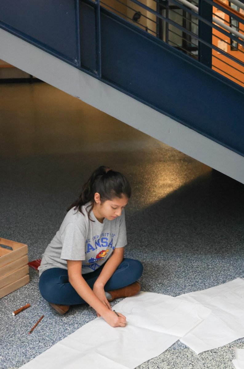 Junior Natalia Castillejos -Ramirez works efficiently on a banner 