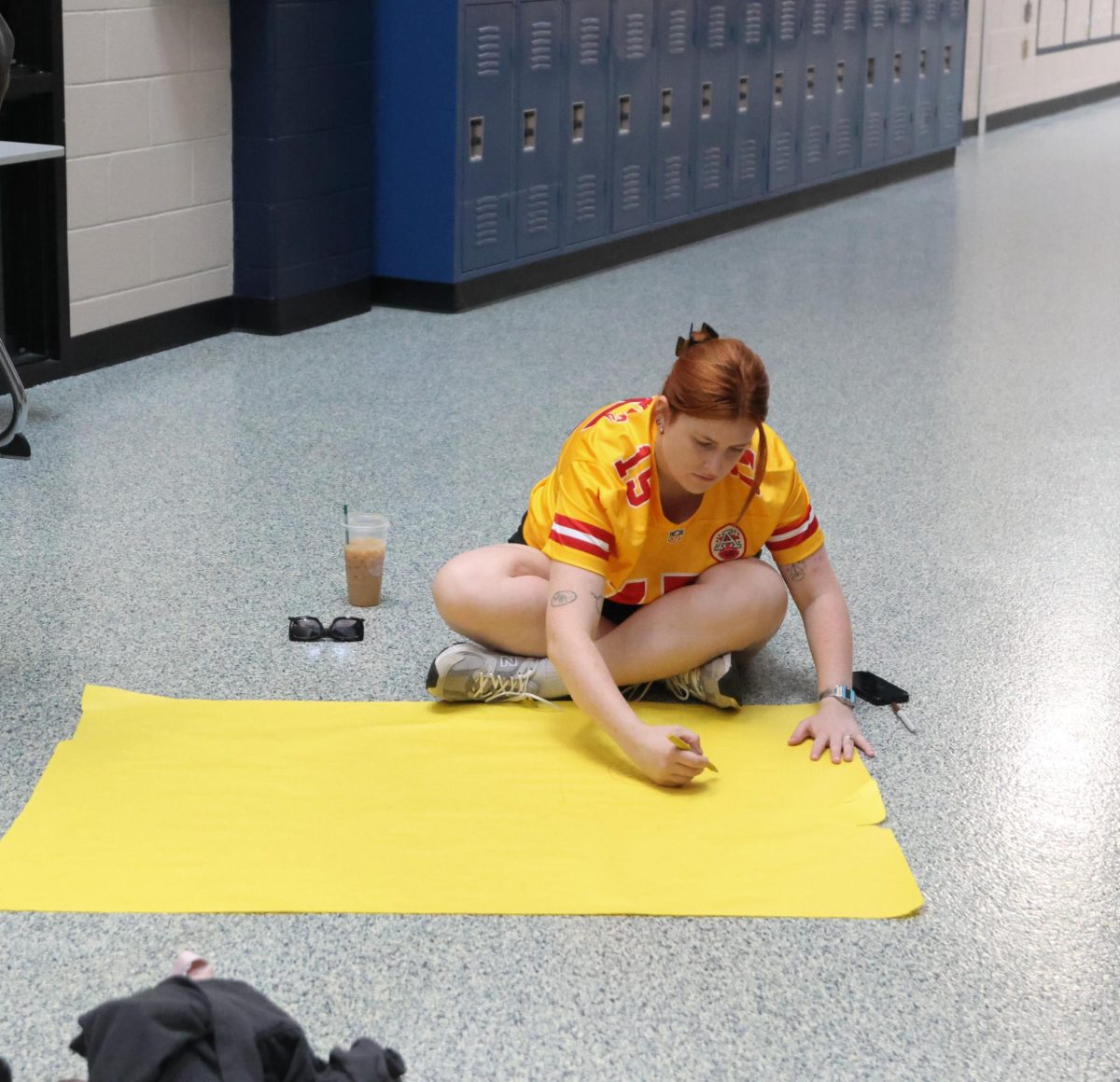 Focusing on her work, science teacher Caroline Conley works on a poster 