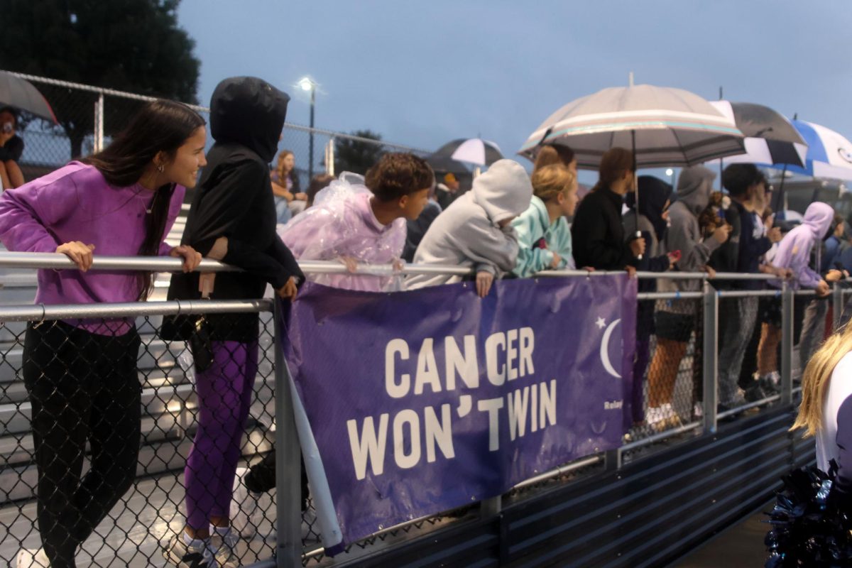 Students help to hold up Relay for Life's "Cancer won't win" sign at the Purple Out RFL varsity soccer game, Tuesday Sept 23.