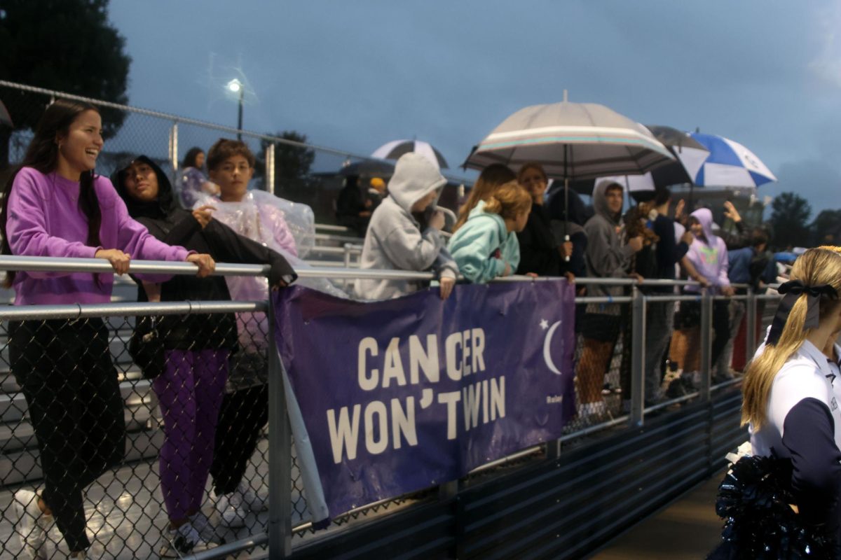 Students smile and laugh with each other, enjoying the Purple Out RFL varsity soccer game , Tuesday Sept 23.