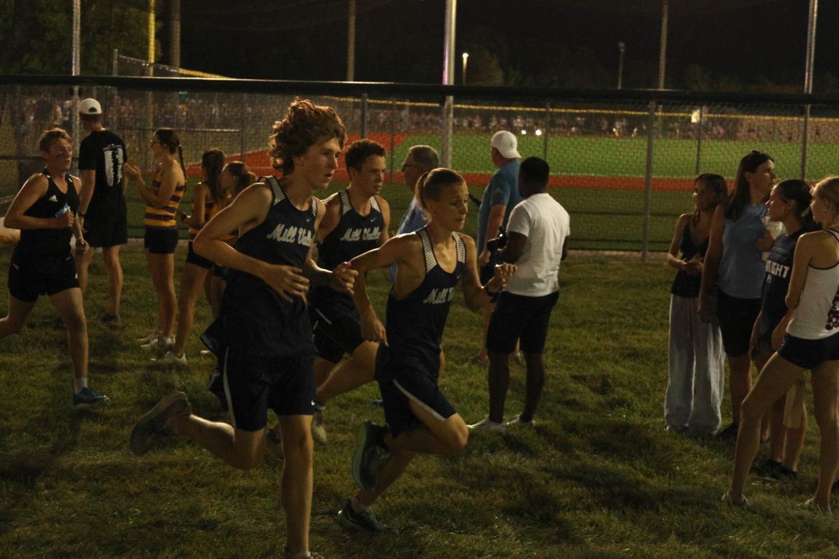 Sprinting together, freshmen Joshua Newman, Xavier DeHaven and junior Jack Niewohnew create steady paces for themselves.