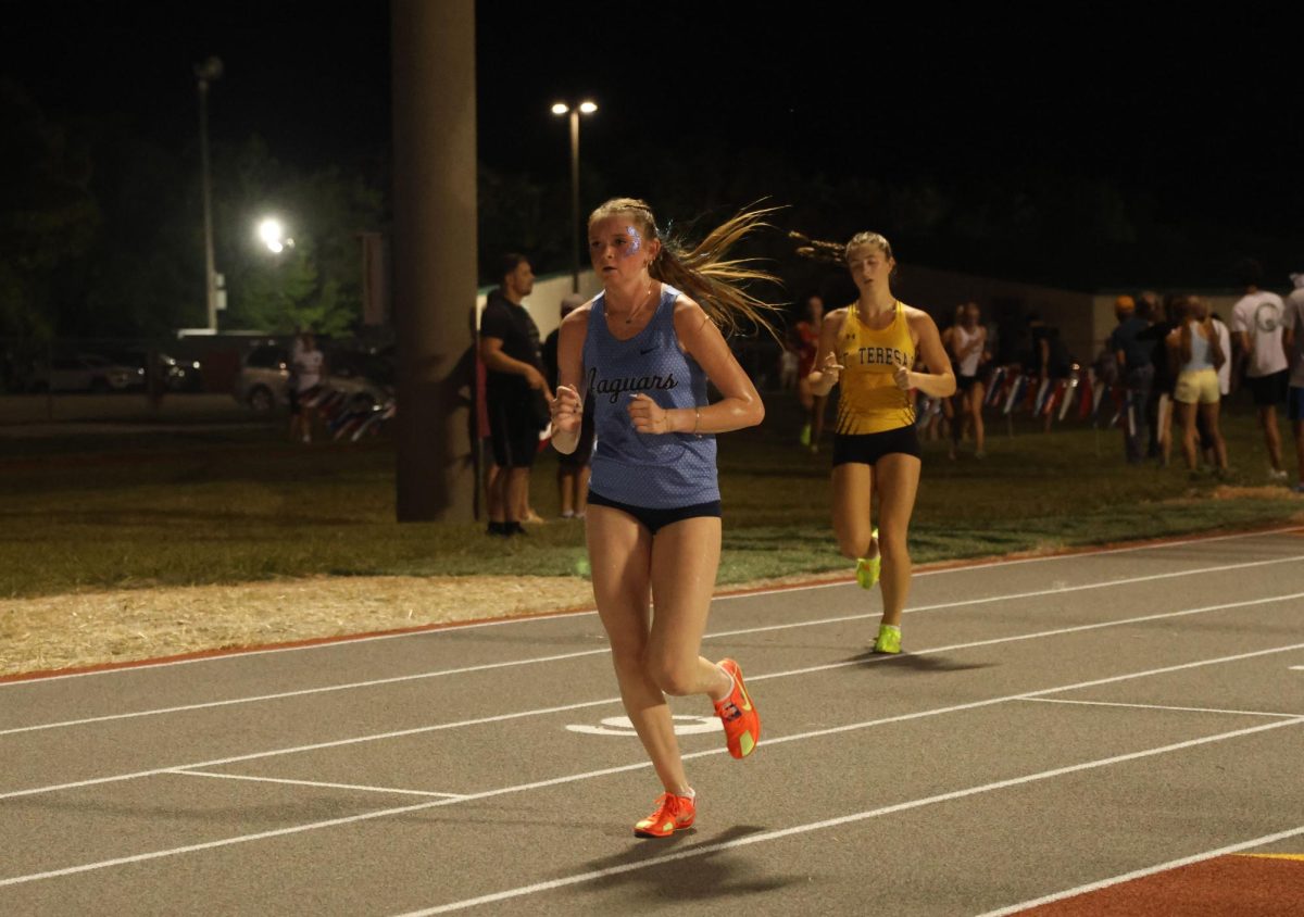 Nearing the finish, junior Avery Johnson stays in front of her competitors.  