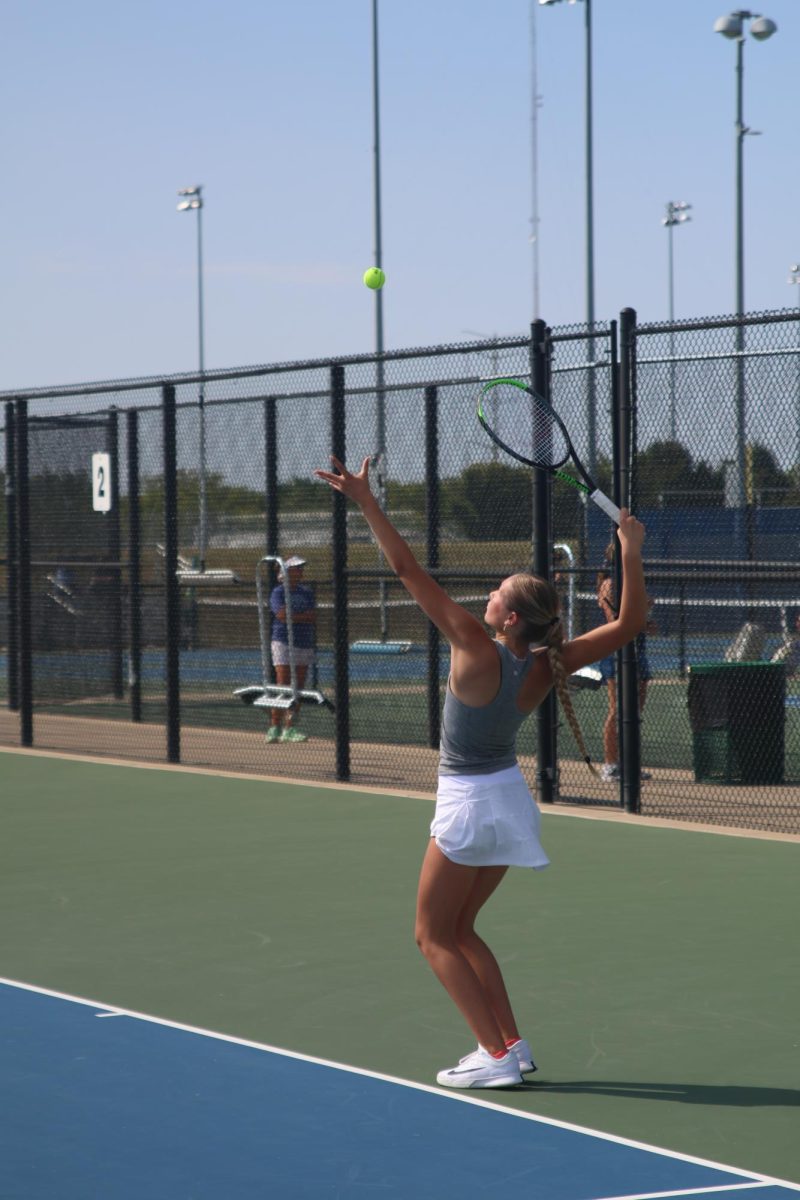 Senior Bryn Foltz throws the ball in the air to serve it to her opponent, Thursday Sept. 11.  