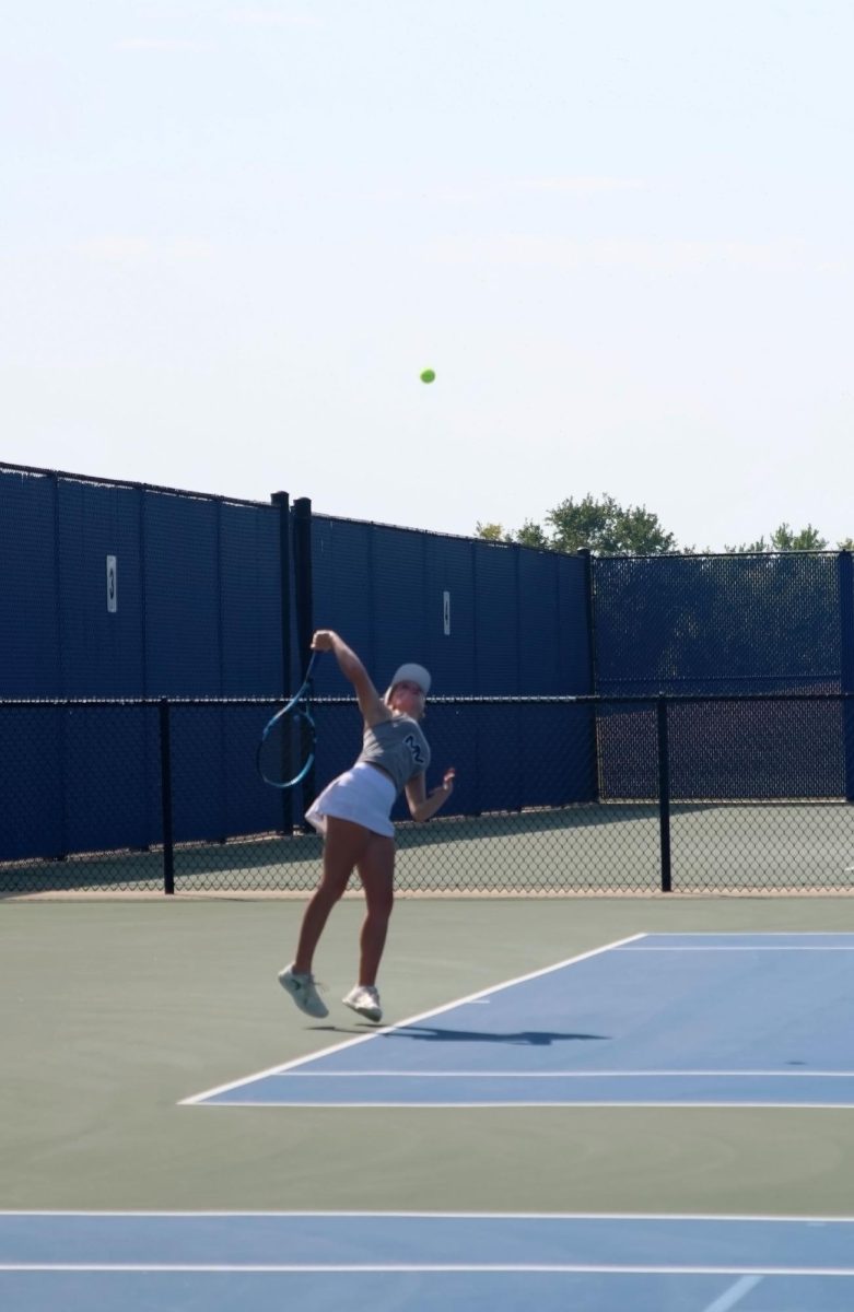 Junior Clara Budimlija serves the ball across the net. 