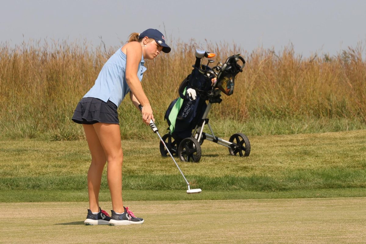 Senior Lola Dumler practices her putting stroke before she hits the ball, Thursday Sept. 4. 