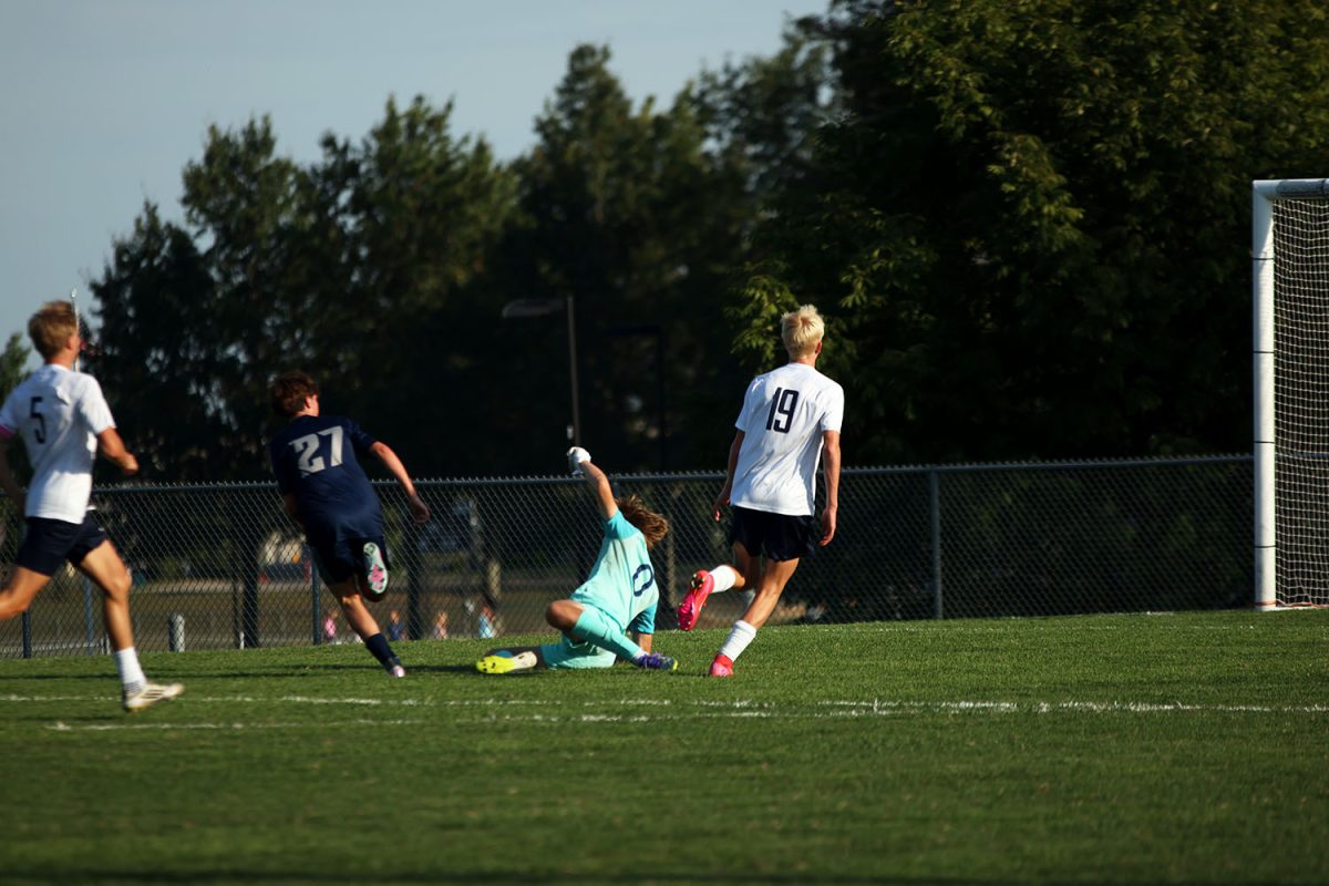 Junior Zane Hodson slides to keep his opponent from scoring. Tuesday Sept. 2.