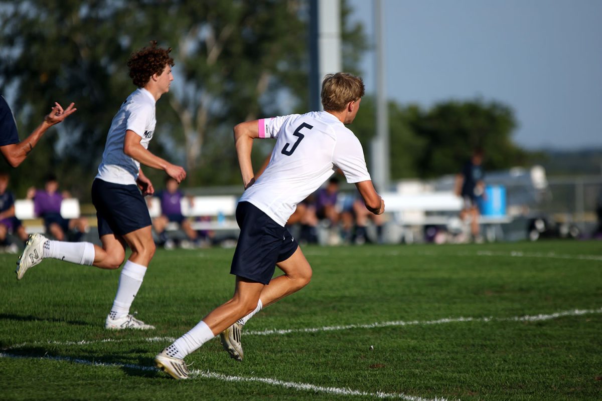 Senior Ayden Kostus runs side by side with Senior Landon Vincent to get the ball back. Tuesday Sept. 2.