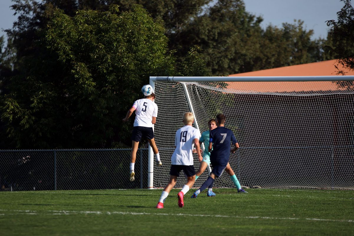 To stop St. James from scoring, senior Ayden Kostus uses his head to bump the ball out of the way. Tuesday Sept. 2.