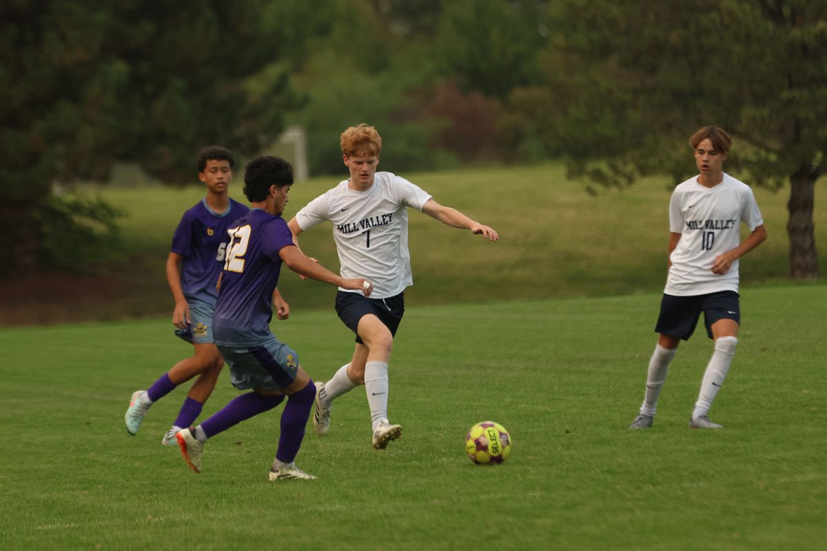 Racing to the ball, senior Caleb Hayes tries to beat his opponent to the ball.