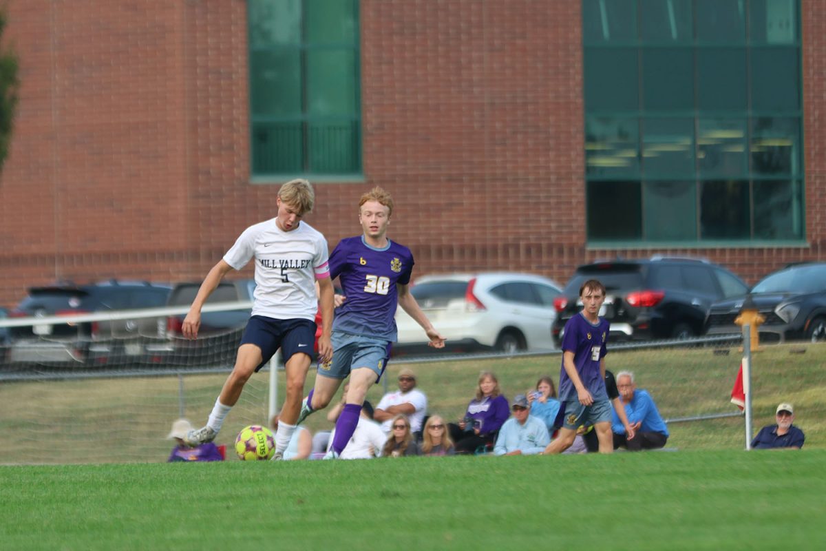 Trying to get past his opponent, senior Ayden Kostus focuses on his footwork.