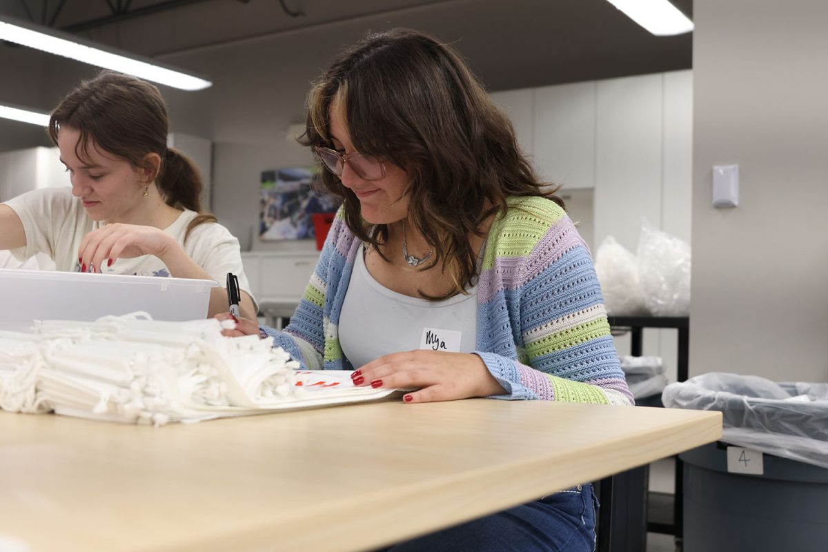 On the second stack of bags, senior Mya Franco writes the date on each bag, Thursday, Sept. 18.