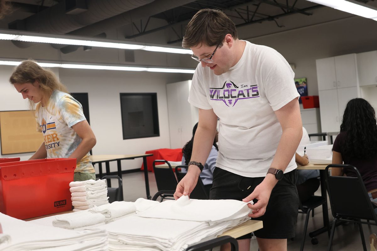 Volunteering at Heart to Heart, seniors Will Schieber and Ian Weatherman talk while folding the towels, Thursday, Sept. 18. 